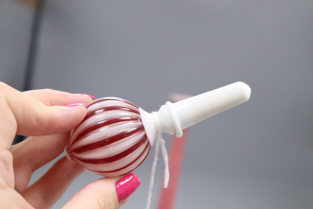 A slender Venetian red and white glass bottle and stopper